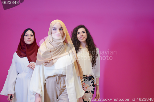 Image of muslim women in fashionable dress isolated on pink