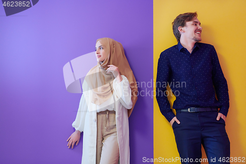 Image of portrait of young muslim couple isolated on colorful background