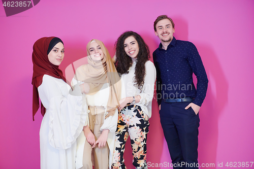 Image of group portrait of young muslim people isolated on pink