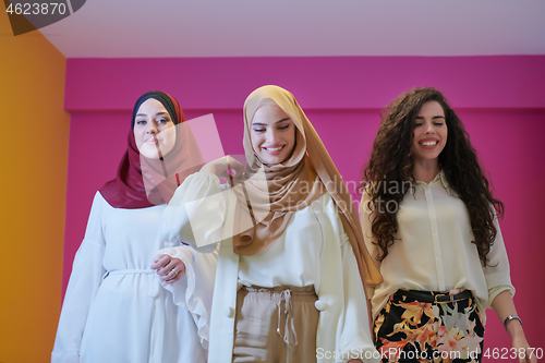 Image of muslim women in fashionable dress isolated on pink