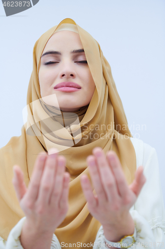 Image of muslim woman making traditional prayer to God