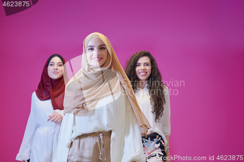 Image of muslim women in fashionable dress isolated on pink