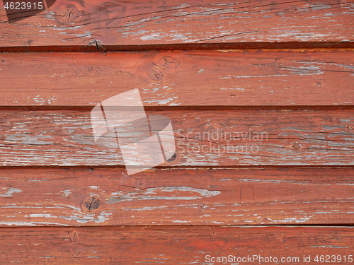 Image of Old weathered wooden roof pained in red