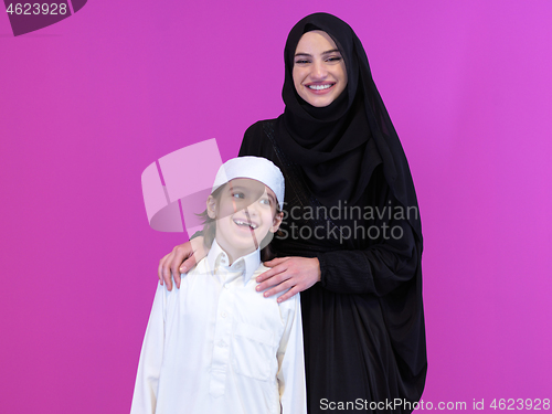 Image of portrait of muslim mother and son on pink background