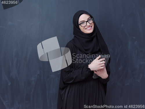 Image of young muslim business woman using tablet computer