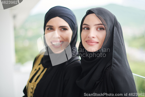 Image of portrait of beautiful muslim women standing on balcony