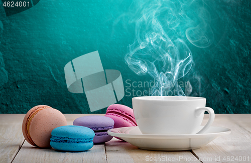 Image of Macaroons with coffee turquoise background