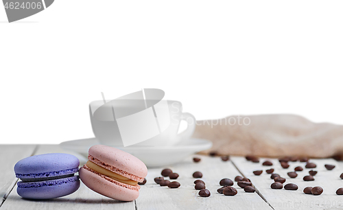 Image of Two macaroons with cup coffee beans
