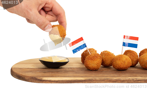 Image of Dutch traditional snack bitterbal in a hand