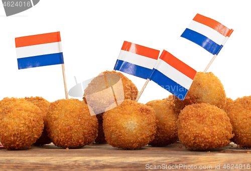 Image of Dutch traditional snack bitterbal on a serving board, dutch flag