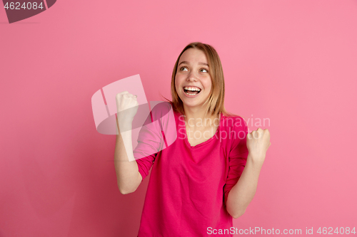 Image of Caucasian young woman\'s monochrome portrait on pink studio background, emotinal and beautiful