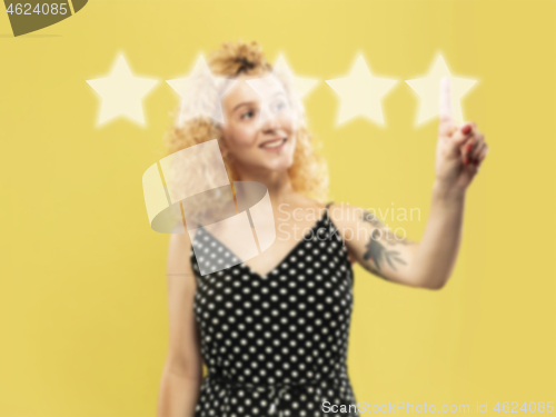 Image of Woman touching five star symbol to increase rating of company, app or service