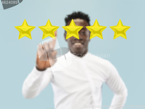 Image of Man touching five star symbol to increase rating of company, app or service