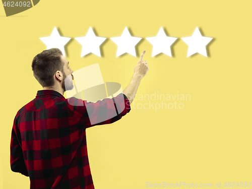 Image of Man touching five star symbol to increase rating of company, app or service