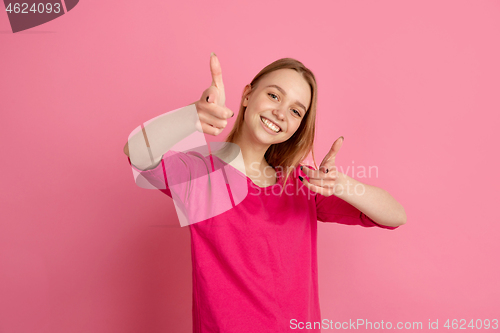 Image of Caucasian young woman\'s monochrome portrait on pink studio background, emotinal and beautiful