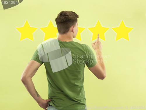 Image of Man touching five star symbol to increase rating of company, app or service