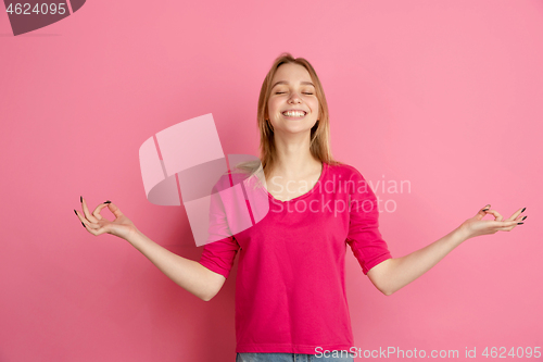 Image of Caucasian young woman\'s monochrome portrait on pink studio background, emotinal and beautiful