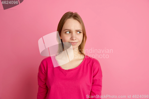 Image of Caucasian young woman\'s monochrome portrait on pink studio background, emotinal and beautiful