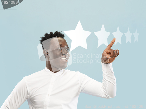 Image of Man touching five star symbol to increase rating of company, app or service