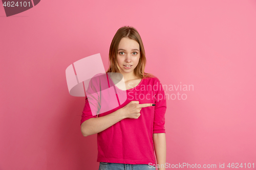 Image of Caucasian young woman\'s monochrome portrait on pink studio background, emotinal and beautiful