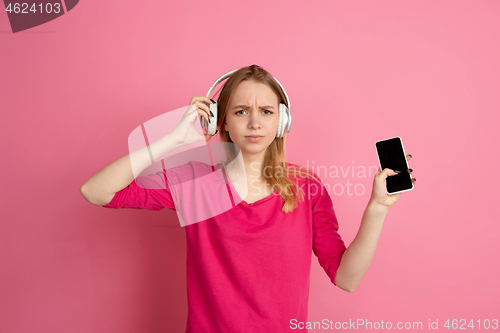 Image of Caucasian young woman\'s monochrome portrait on pink studio background, emotinal and beautiful