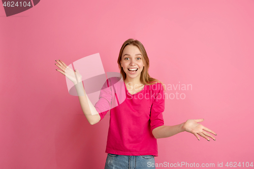 Image of Caucasian young woman\'s monochrome portrait on pink studio background, emotinal and beautiful