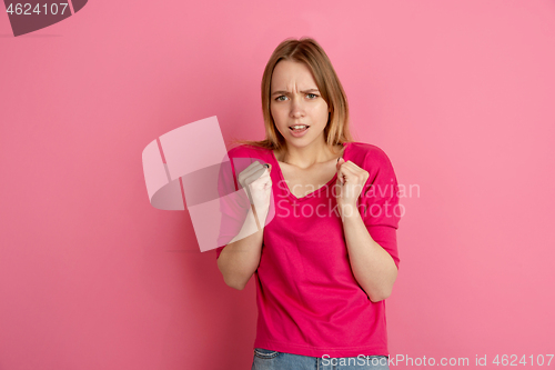 Image of Caucasian young woman\'s monochrome portrait on pink studio background, emotinal and beautiful