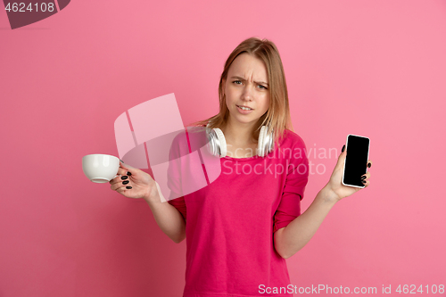 Image of Caucasian young woman\'s monochrome portrait on pink studio background, emotinal and beautiful