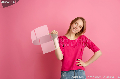 Image of Caucasian young woman\'s monochrome portrait on pink studio background, emotinal and beautiful