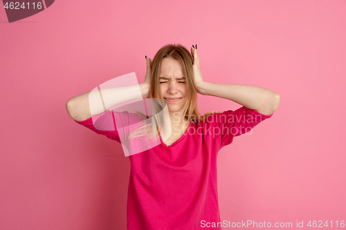 Image of Caucasian young woman\'s monochrome portrait on pink studio background, emotinal and beautiful