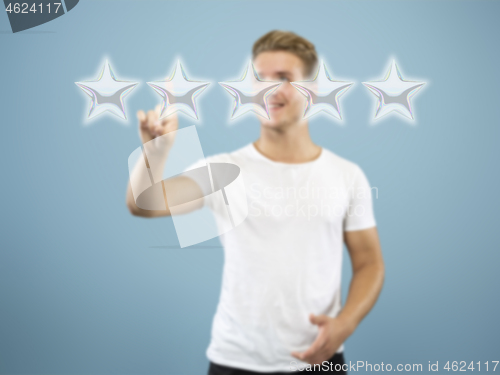 Image of Man touching five star symbol to increase rating of company, app or service