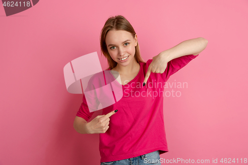 Image of Caucasian young woman\'s monochrome portrait on pink studio background, emotinal and beautiful