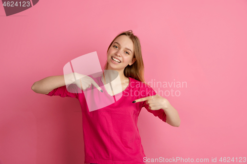 Image of Caucasian young woman\'s monochrome portrait on pink studio background, emotinal and beautiful