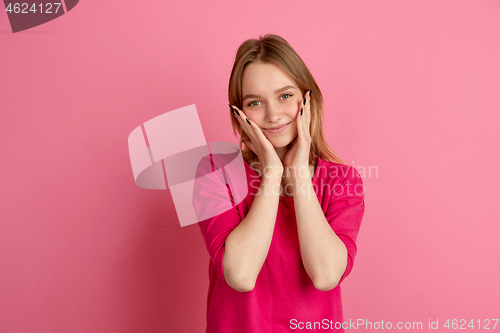 Image of Caucasian young woman\'s monochrome portrait on pink studio background, emotinal and beautiful