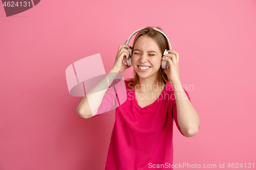 Image of Caucasian young woman\'s monochrome portrait on pink studio background, emotinal and beautiful