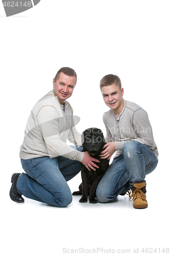 Image of Father and son with dog