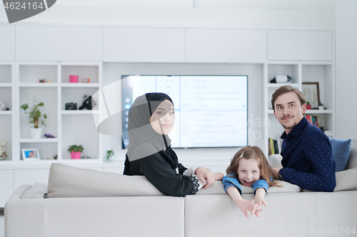 Image of Happy Muslim family having fun at home