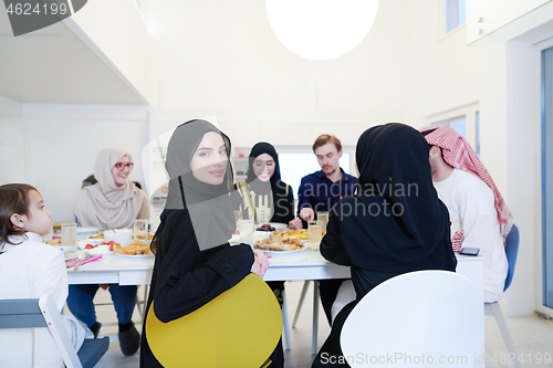 Image of young muslim woman having Iftar dinner with family