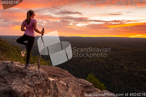 Image of Woman serenity yoga while watching magnificent sunset