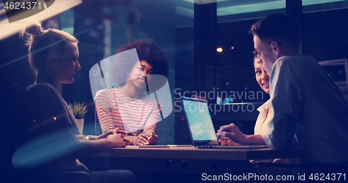 Image of Multiethnic startup business team in night office