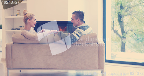 Image of Young couple  in front of fireplace