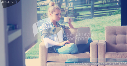 Image of woman drinking coffee enjoying relaxing lifestyle