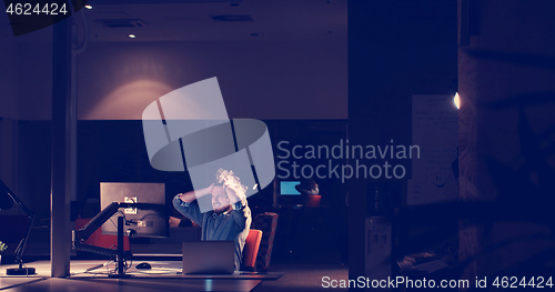 Image of businessman relaxing at the desk