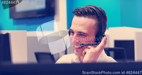 Image of male call centre operator doing his job