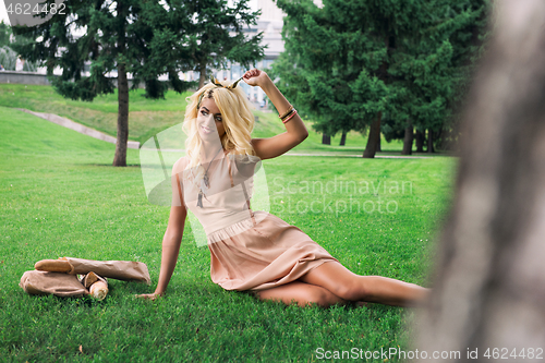 Image of eauty blonde alone young woman resting in the park