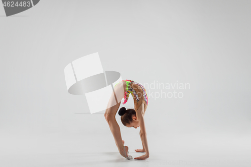 Image of The teenager girl doing gymnastics exercises isolated on white background