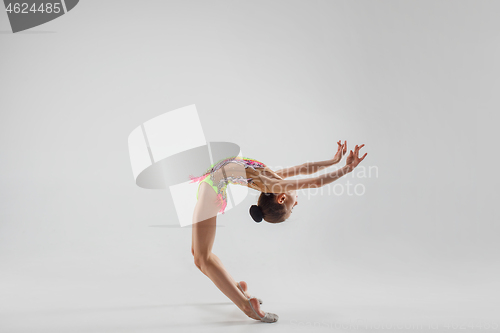 Image of The teenager girl doing gymnastics exercises isolated on white background