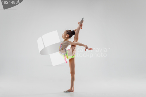 Image of The teenager girl doing gymnastics exercises isolated on white background