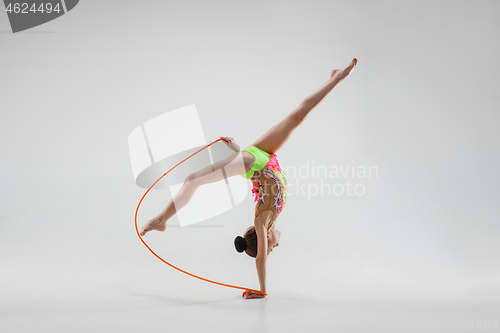 Image of The teenager girl doing gymnastics exercises isolated on white background