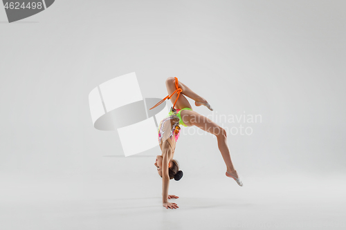 Image of The teenager girl doing gymnastics exercises isolated on white background